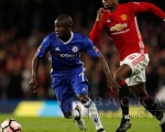 Manchester Uniteds Paul Pogba in action with Chelseas NGolo Kante